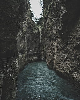 body of water between two rock formation, river between mountains HD wallpaper
