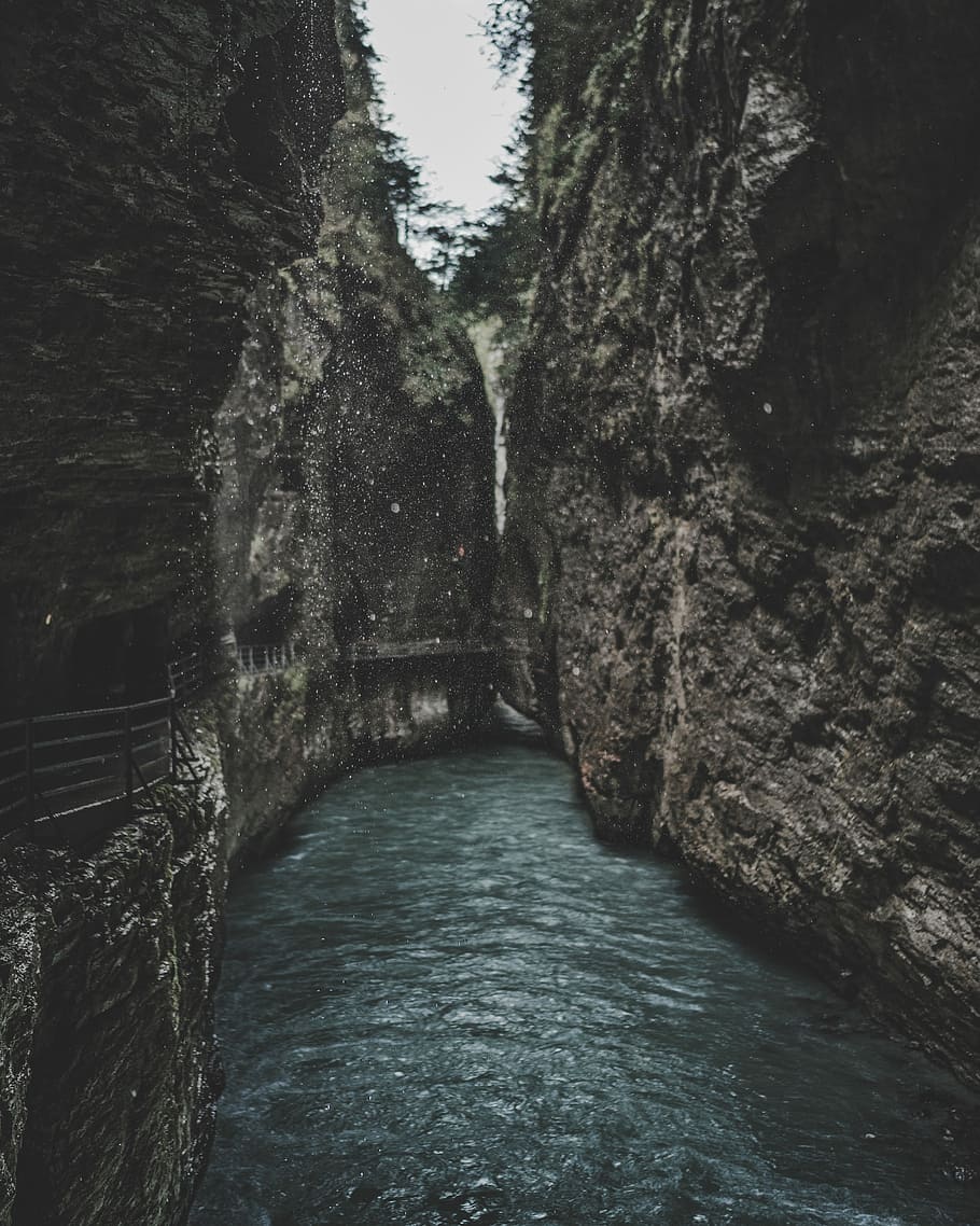 body of water between two rock formation, river between mountains HD wallpaper