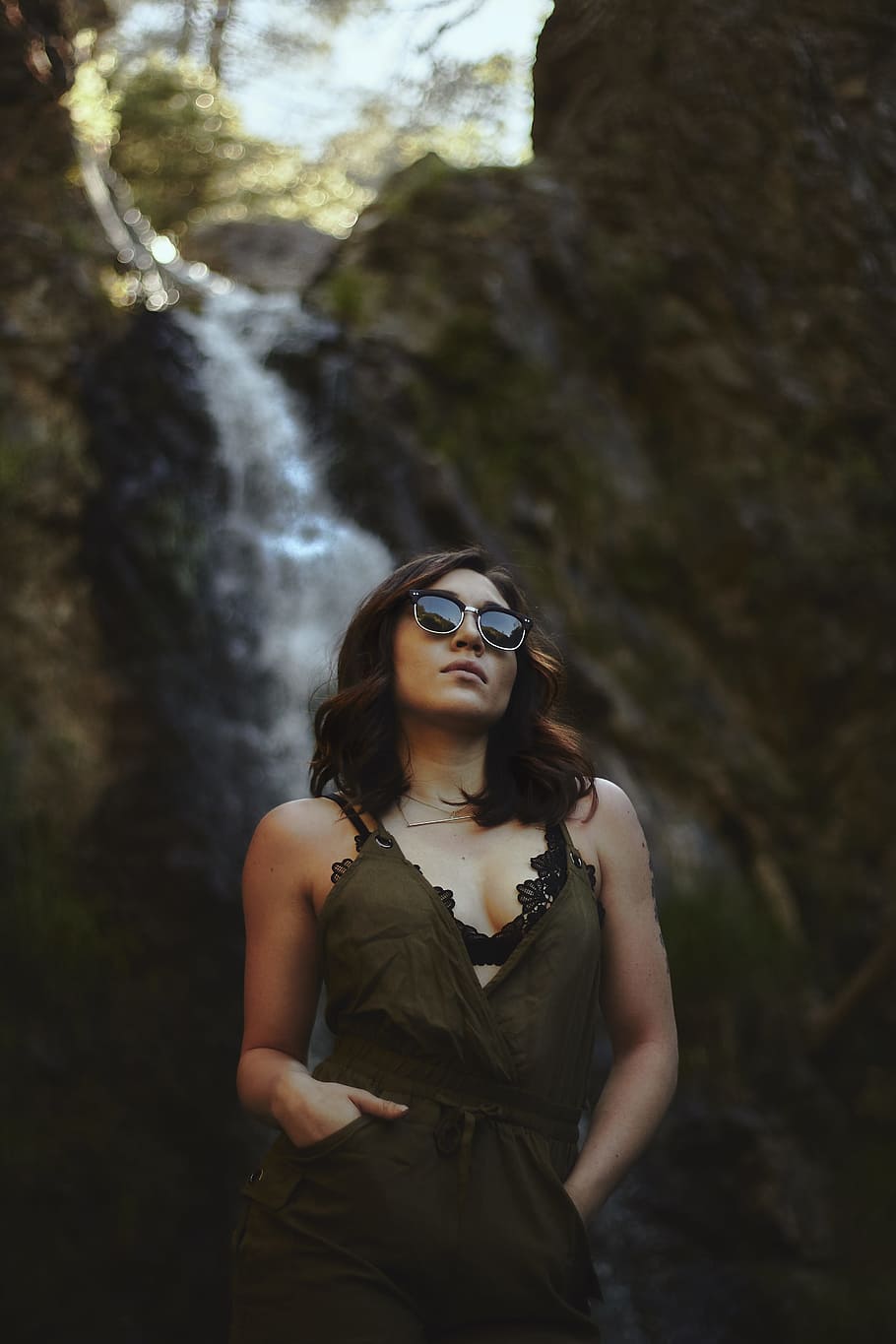 woman wearing black sunglasses, black scooped neck dress near in waterfalls during day time HD wallpaper