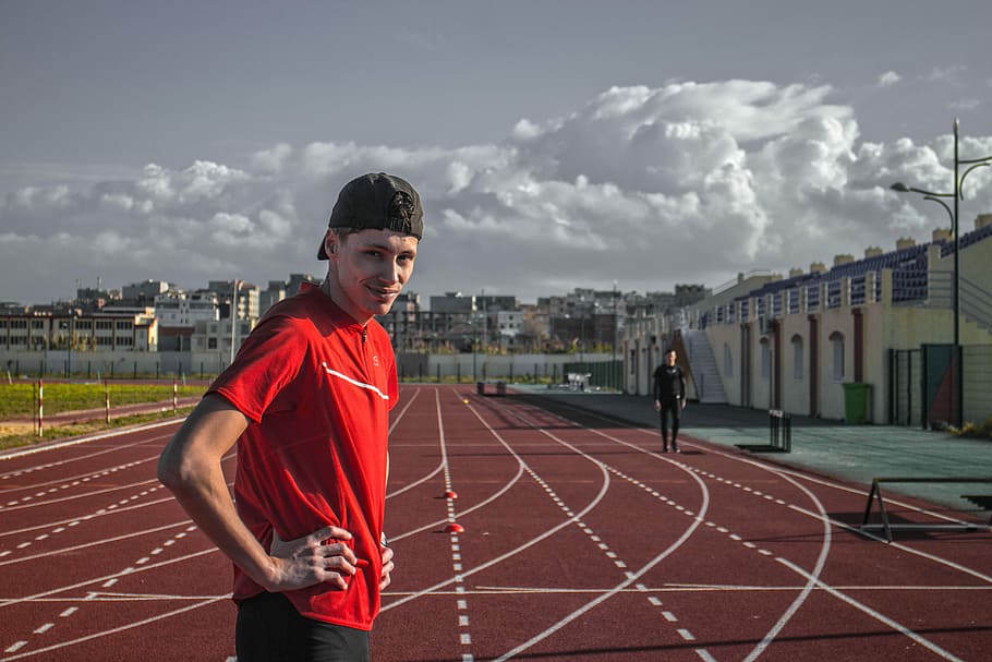 man standing on trackfield, race, running, cloud, building HD wallpaper