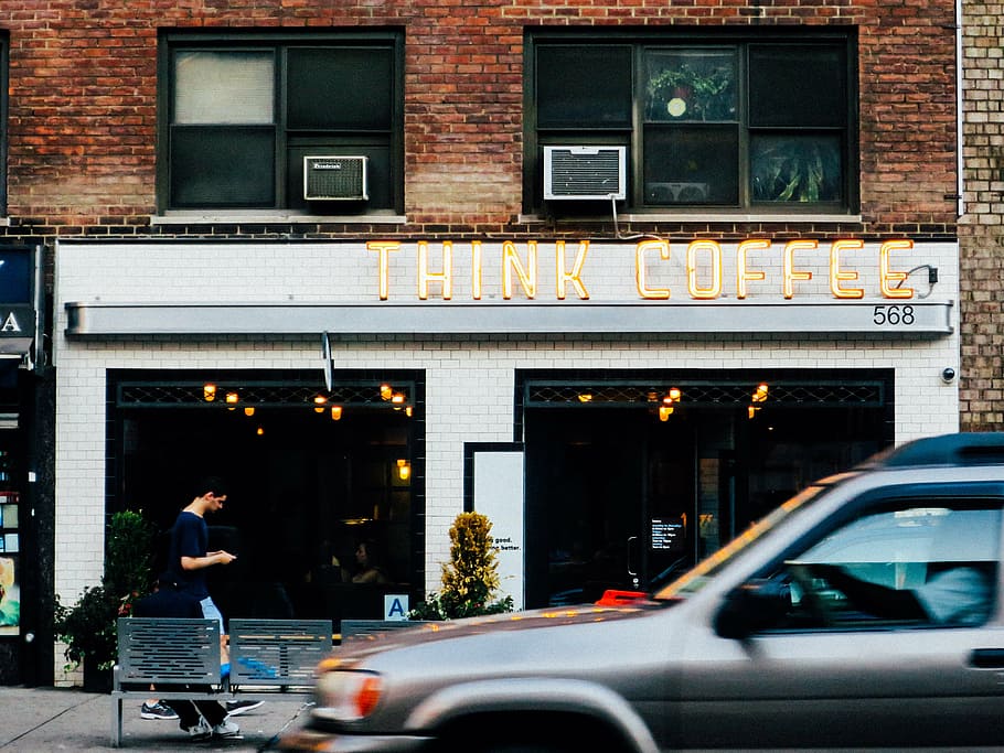 silver vehicle on road on front of Think Coffee shop building HD wallpaper