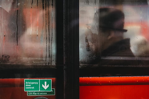 man inside red vehicle view from glass window, man in black hat in store HD wallpaper