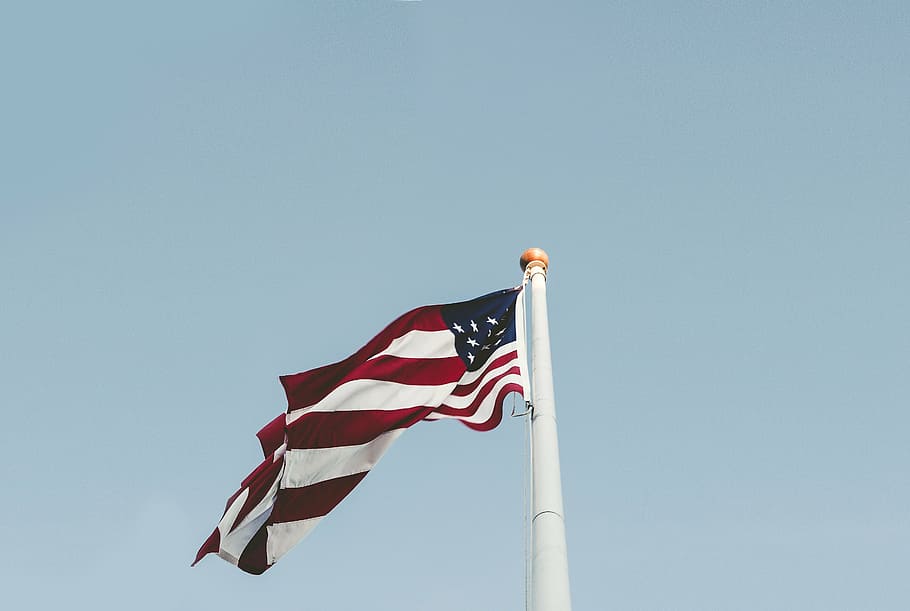United States of America flat on white pole taken during daytime
