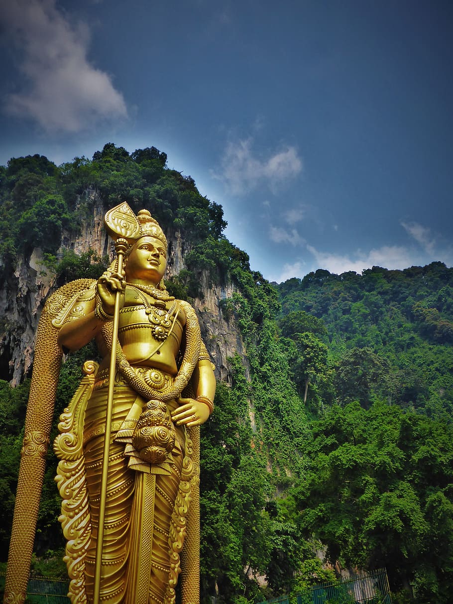 gold statue outdoor during daytime, malaysia, temple, hindu, religion