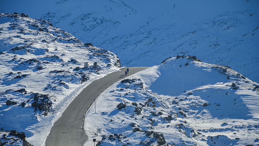 bird's eye photography of two people walking on road between snowfield, photography of two person walking on road surrounded by snow HD wallpaper