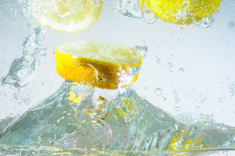 sliced lemon fruit on water, inject, spray, water splashes HD wallpaper