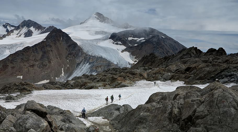 group of people hiking on snowy mountains, people waling on mountain covered with snow during daytime HD wallpaper