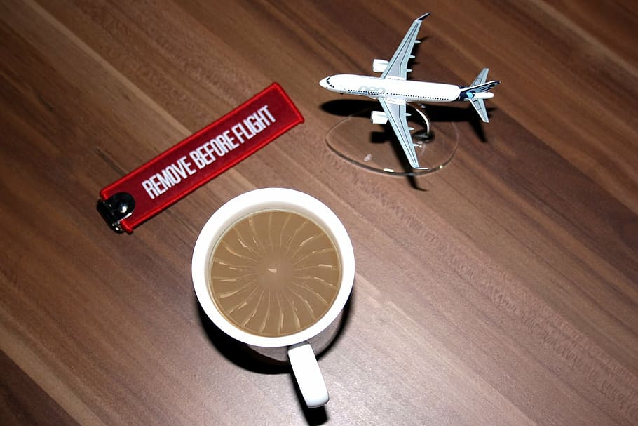 white airliner toy beside teacup on brown wooden surface, aircraft HD wallpaper