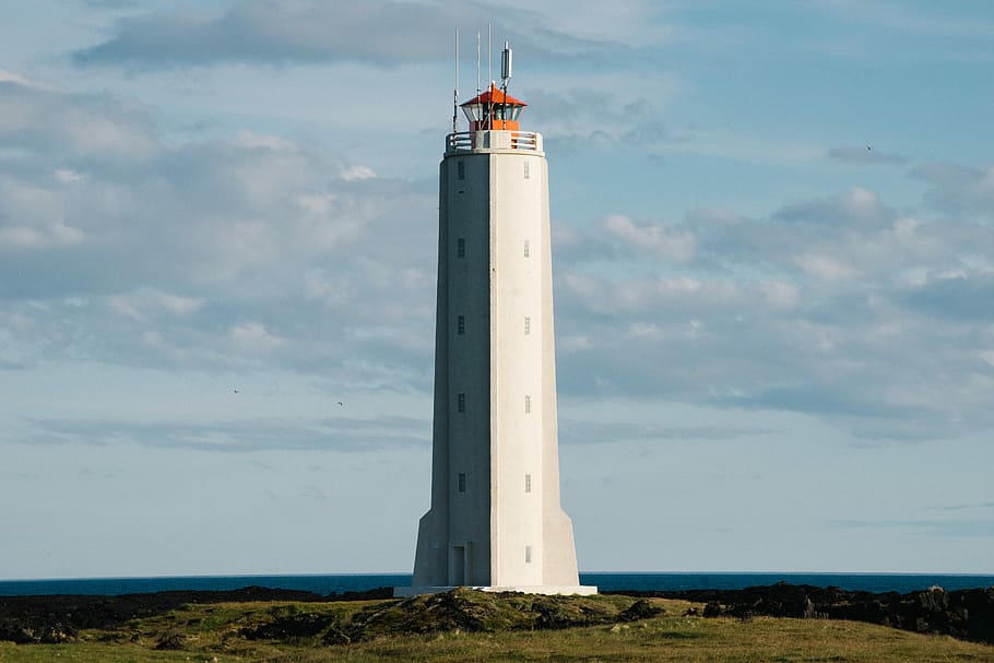 white lighthouse near body of water, white concrete lighthouse at daytime HD wallpaper