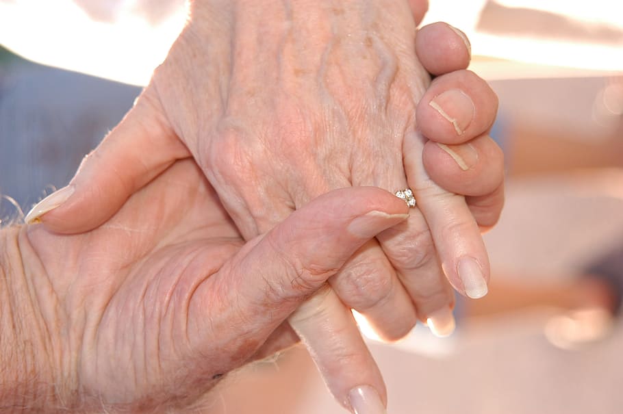 selective focus photography of person holding hands together