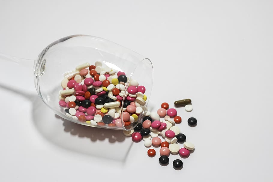clear footed glass pouring medication tablet and capsule, medications HD wallpaper