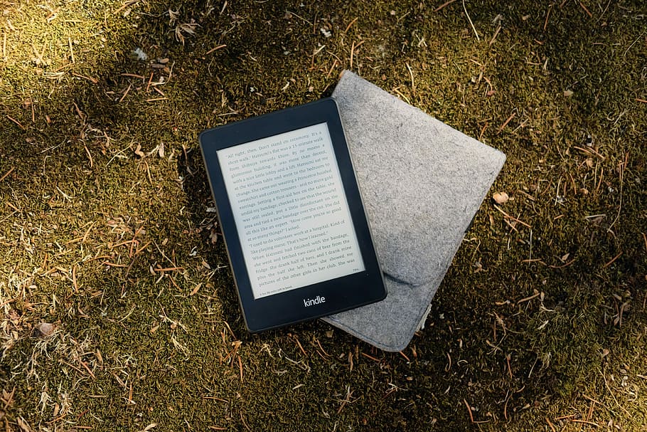 Kindle e-book reader on gray flip cover case, black Amazon Kindle