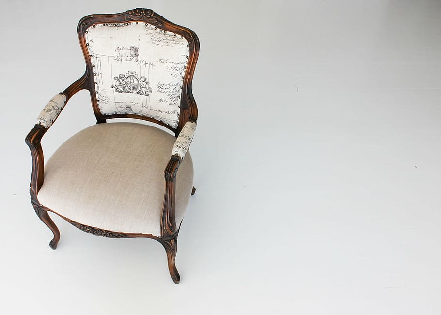 photo of brown wooden framed white padded armchair, furniture