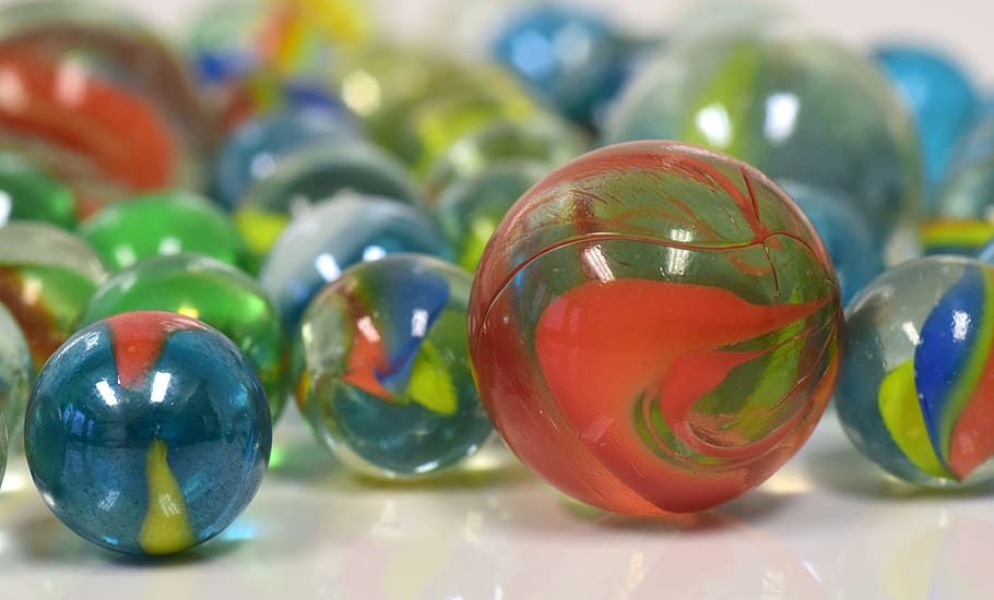 selective focus photography of marble toys, marbles, glass, children toys