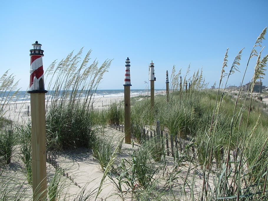 lighthouse, beach, coast, sand, dunes, grass, fence posts, sky HD wallpaper