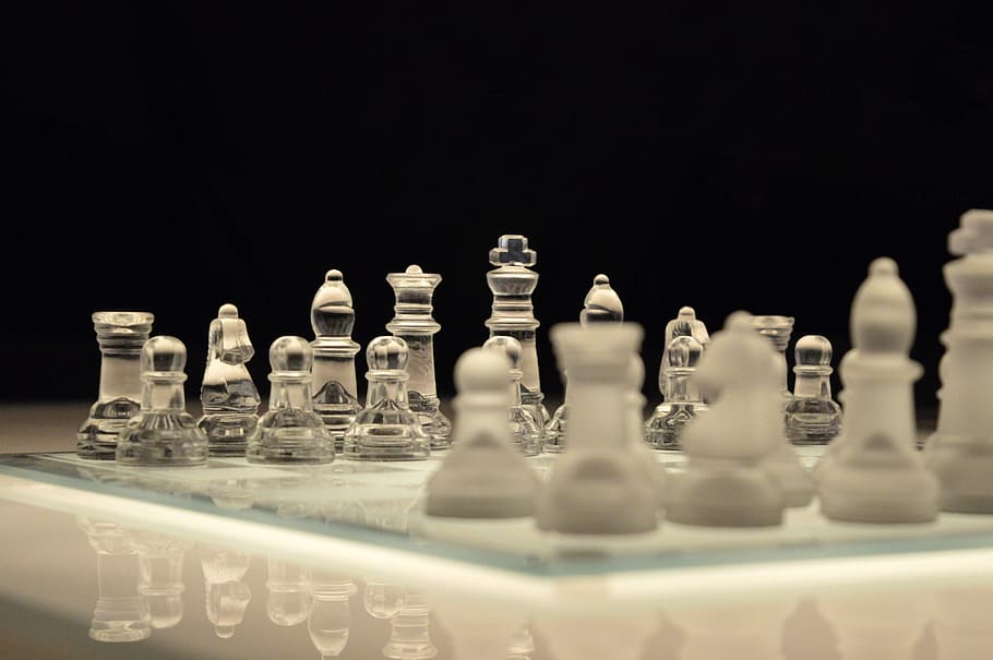 Clear Glass and White Chess Piece on White Chess Board With Black Background HD wallpaper
