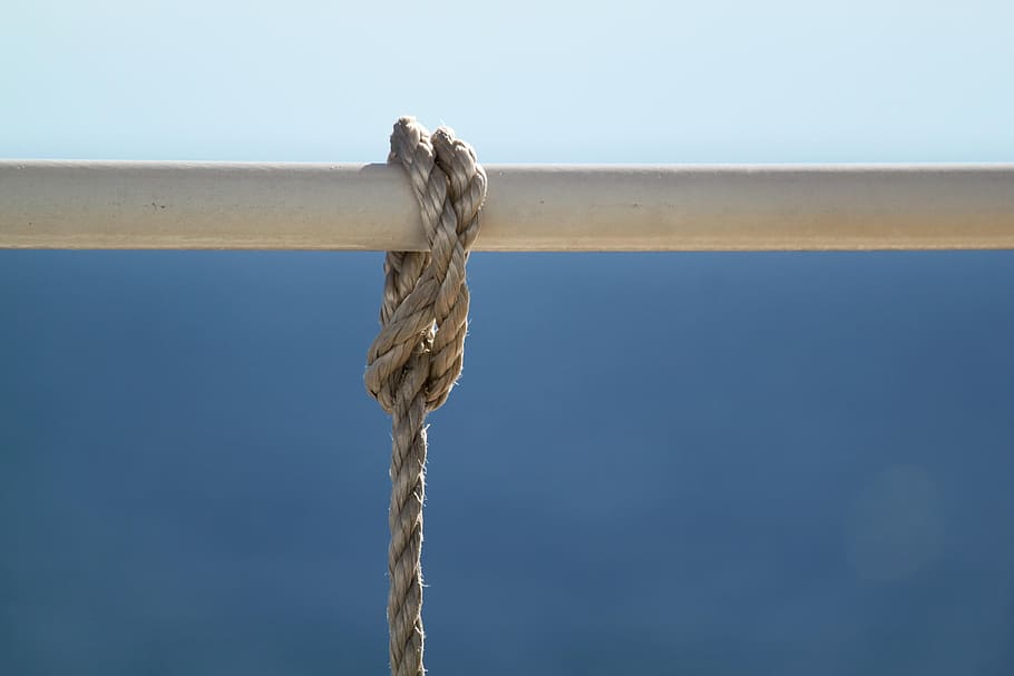 brown rope tied on white metal bar during daytime, knot, cordage