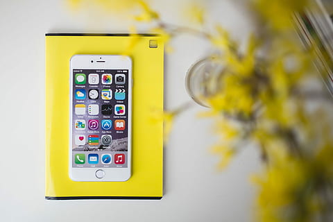 White smartphone with yellow flowers, notebook, cell phone, notepad HD wallpaper