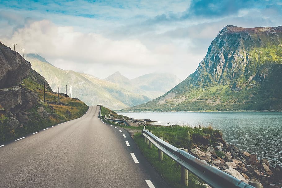 empty road beside body of water, road with mountains background view HD wallpaper