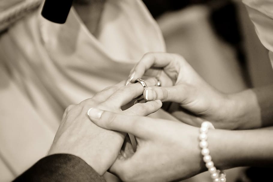 grayscale photography of person holding silver-colored wedding ring HD wallpaper