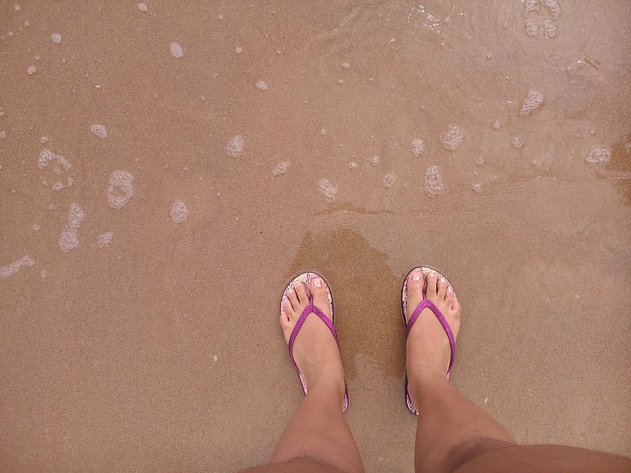 person standing on sand beside body of water, flip flops, feet HD wallpaper