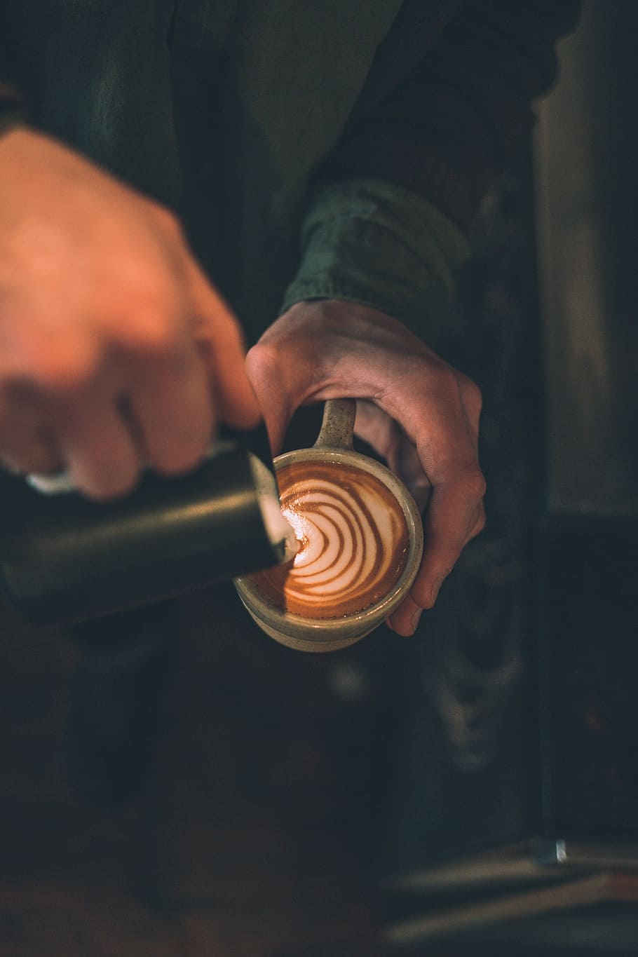 man pouring latte art to cup filled with coffee, person creating latte art HD wallpaper