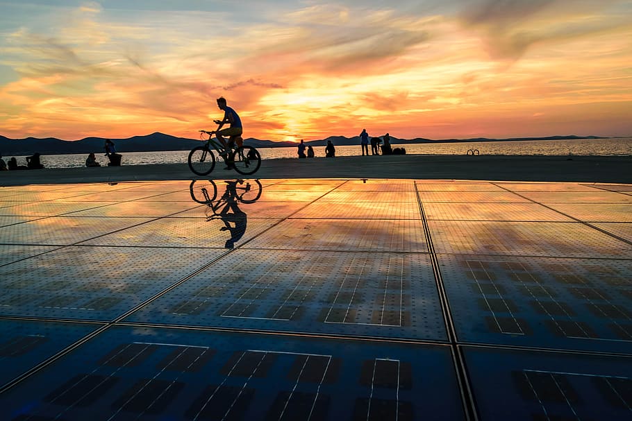 man cycling on shore silhouette photography, zadar, croatia, sea organ