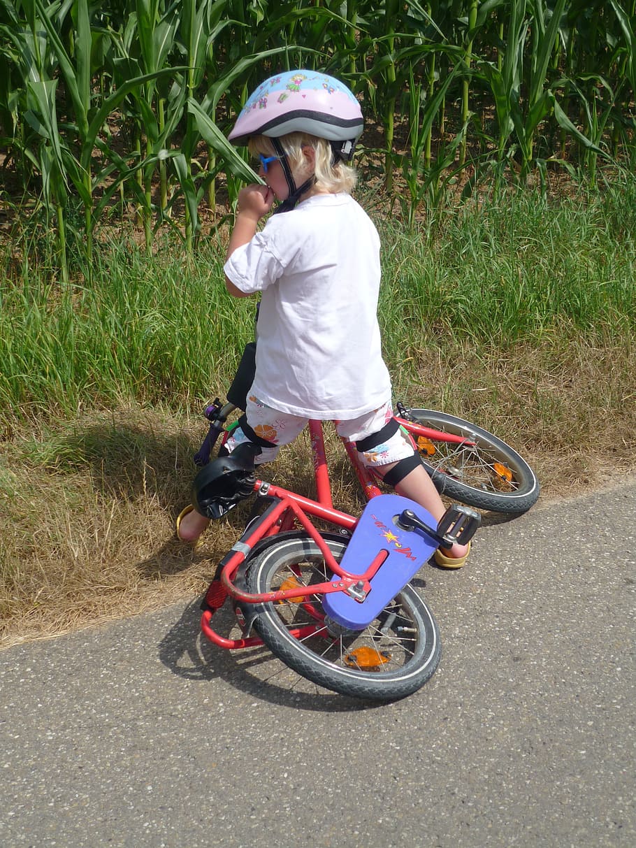 boy riding red bicycle on road, child, bicycle helmet, bike, fall, HD wallpaper