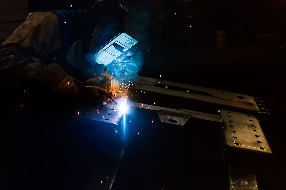 person welding on black metal frame, welder, work, machine, technology