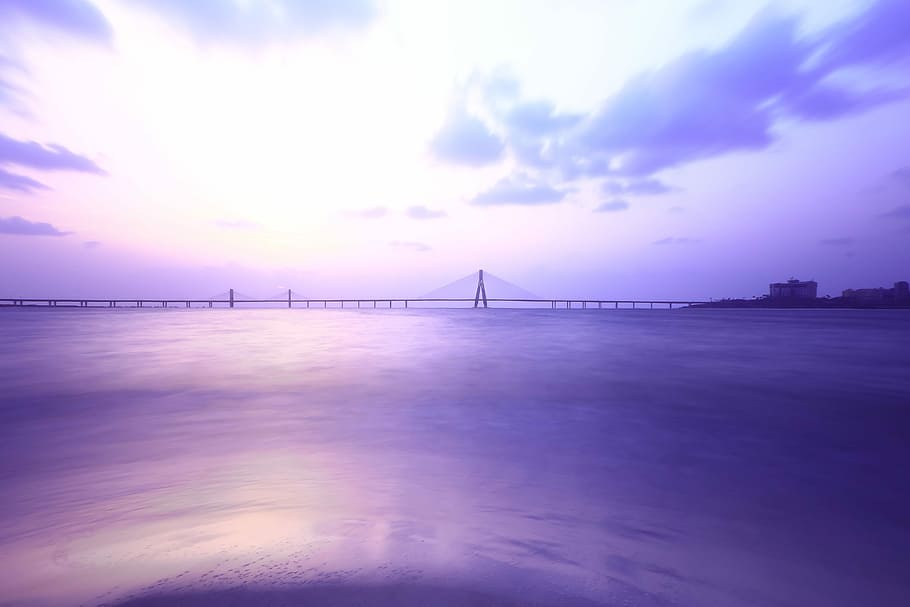 wide angle photo of suspension bridge under cloudy sky, ocean, HD wallpaper