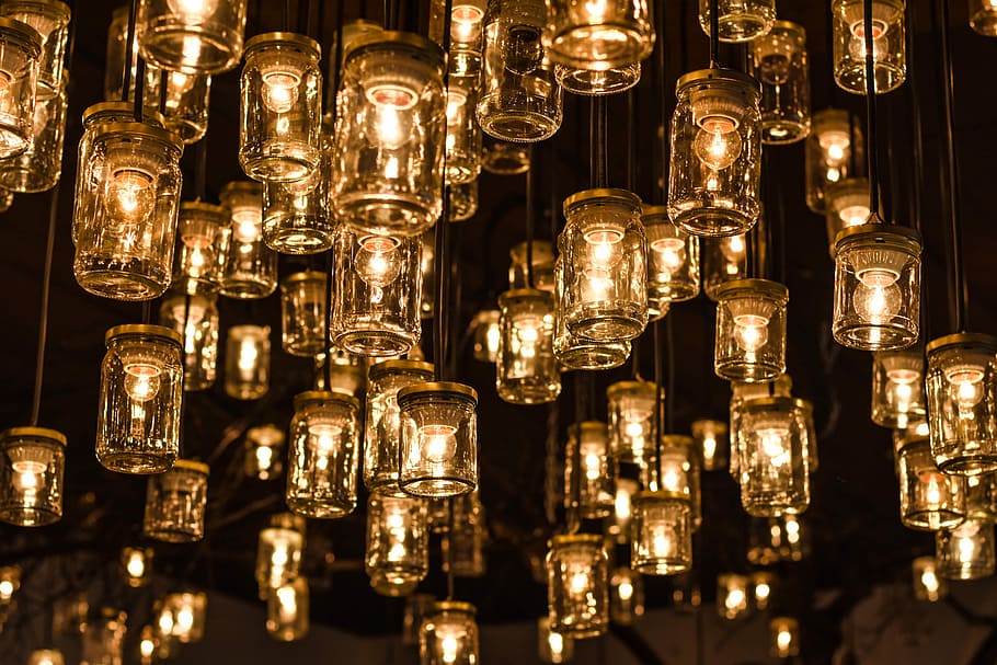 orange pendant lights, photography of hanging clear glass jars with bulbs at nightime