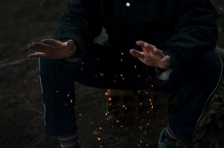 person in black robe, person in black pants sits on stone, fire HD wallpaper