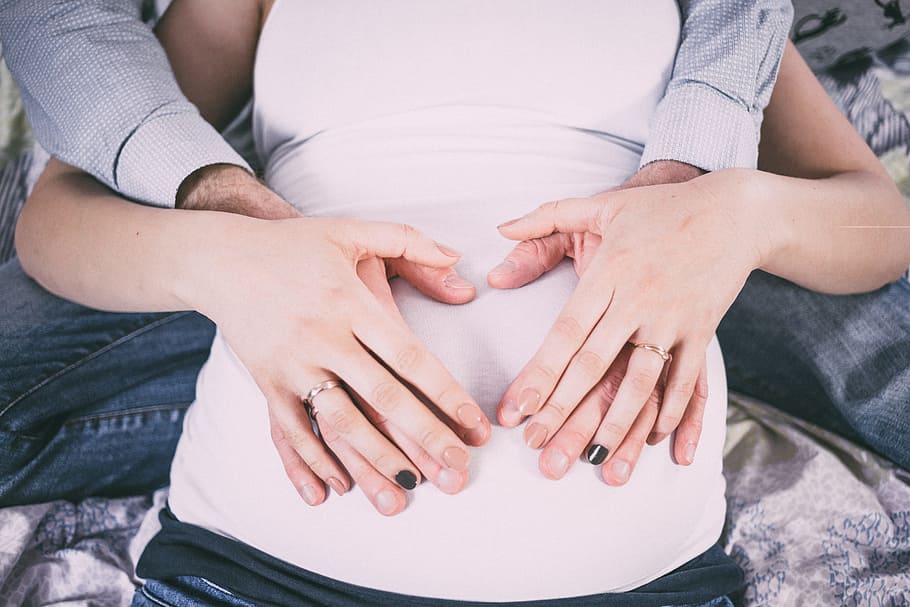 man and woman holding stomach, people, baby, belly, birth, bond