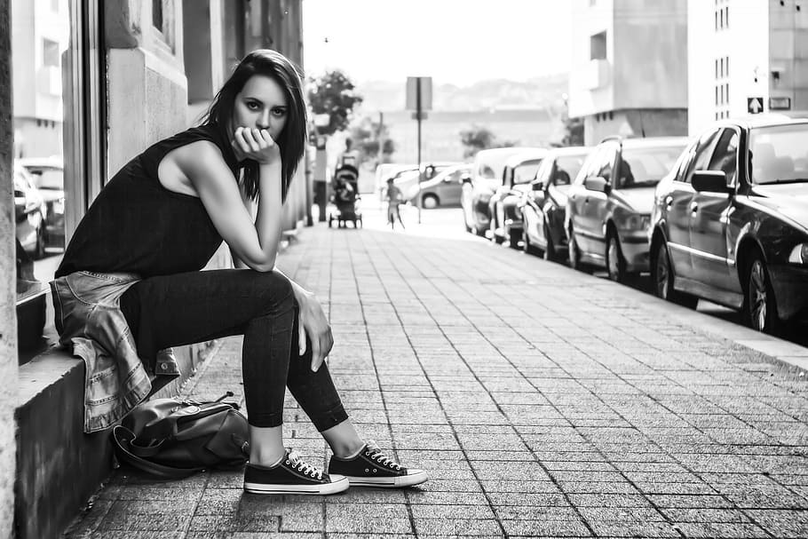 grayscale photography of woman wearing black top sitting on window rack HD wallpaper