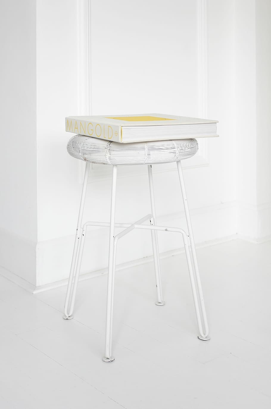 Mangold box on white stool, white mangold book on white bar stool HD wallpaper