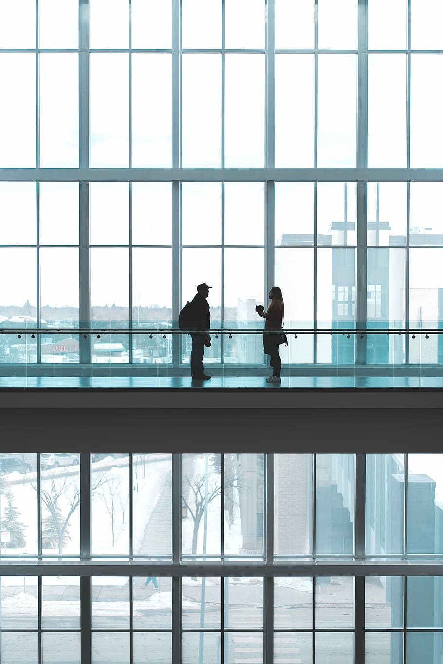 two person talking to each other, man and woman talking inside glass building HD wallpaper