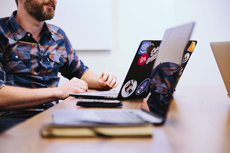 man sitting in front of laptop, man sitting on chair near table facing laptop computer HD wallpaper