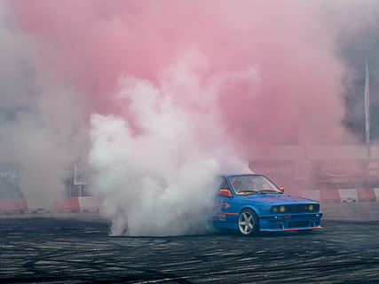 photo of blue car drifting on roadway with smoke at the back HD wallpaper