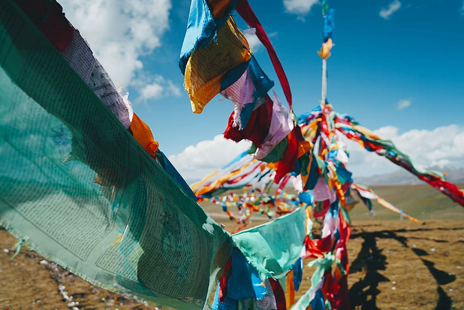 assorted-color textile hangs under clear blue sky during daytime, untitled HD wallpaper