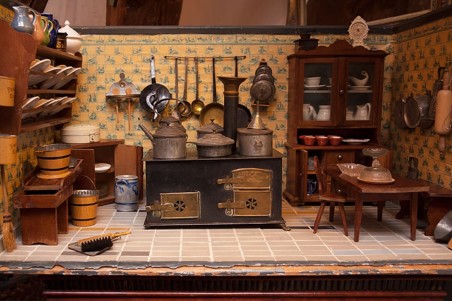 brown wooden display cabinet; black wooden side table; assorted kitchen utensils