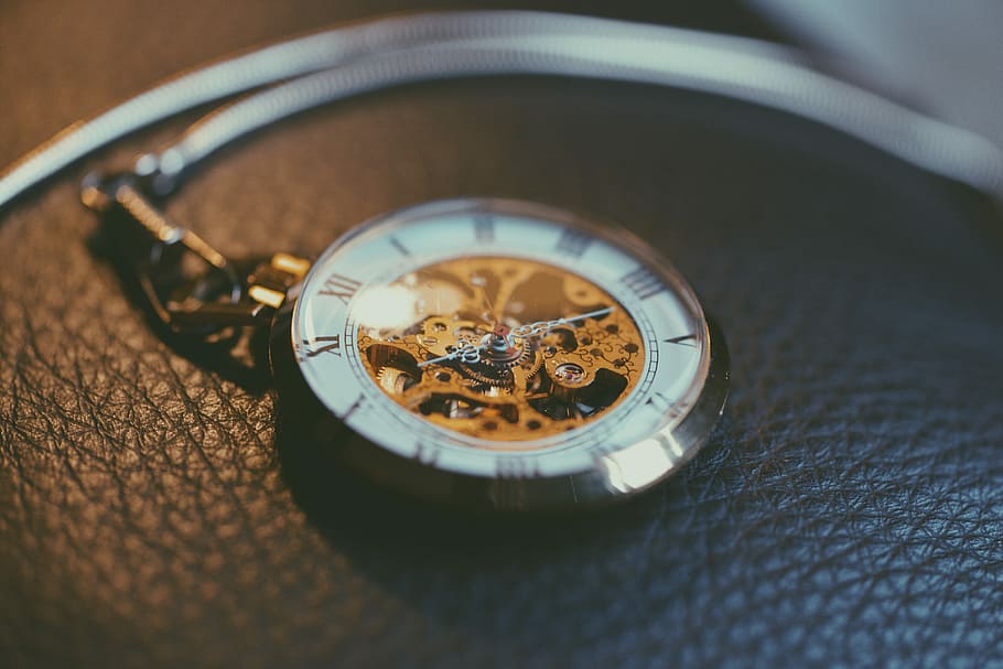 round silver-colored frame skeleton pocket watch, shallow focus photography of mechanical pocket watch HD wallpaper
