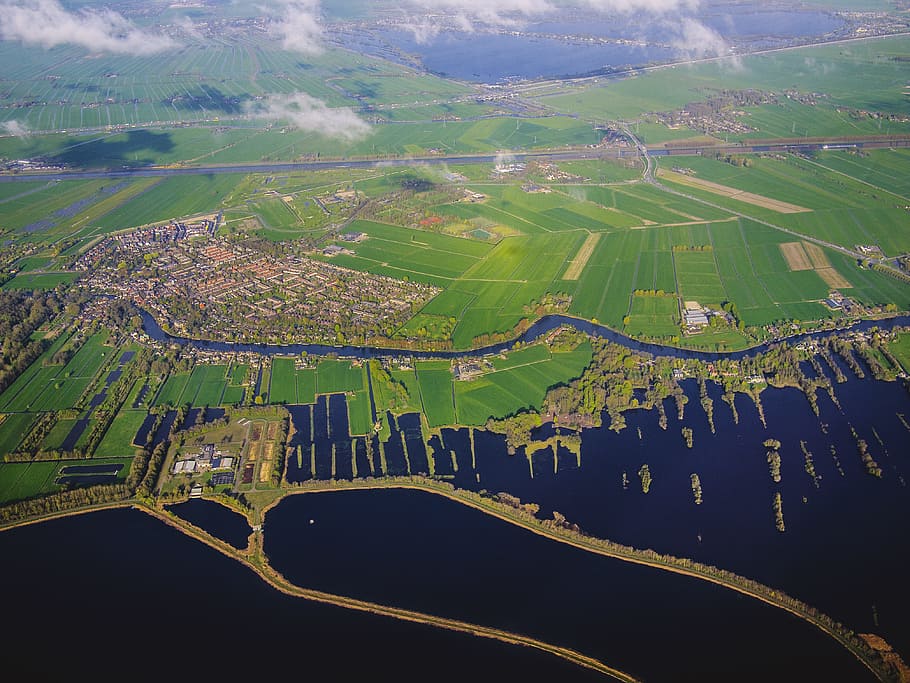 aerial view of green field, aerial photography of green field near calm water HD wallpaper