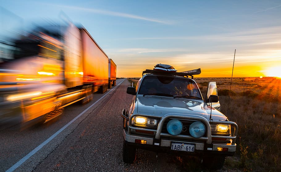 gray car parked beside the road during golden hour photography, vehicle traveling on road during sunset HD wallpaper