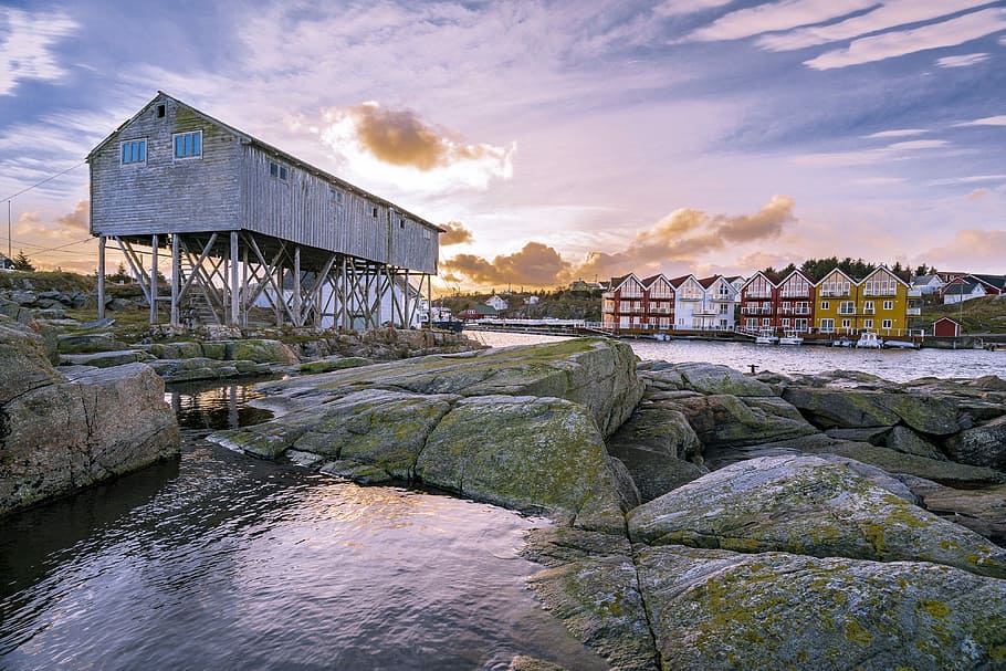 assorted houses near body of water during daytime, white factory near rock HD wallpaper