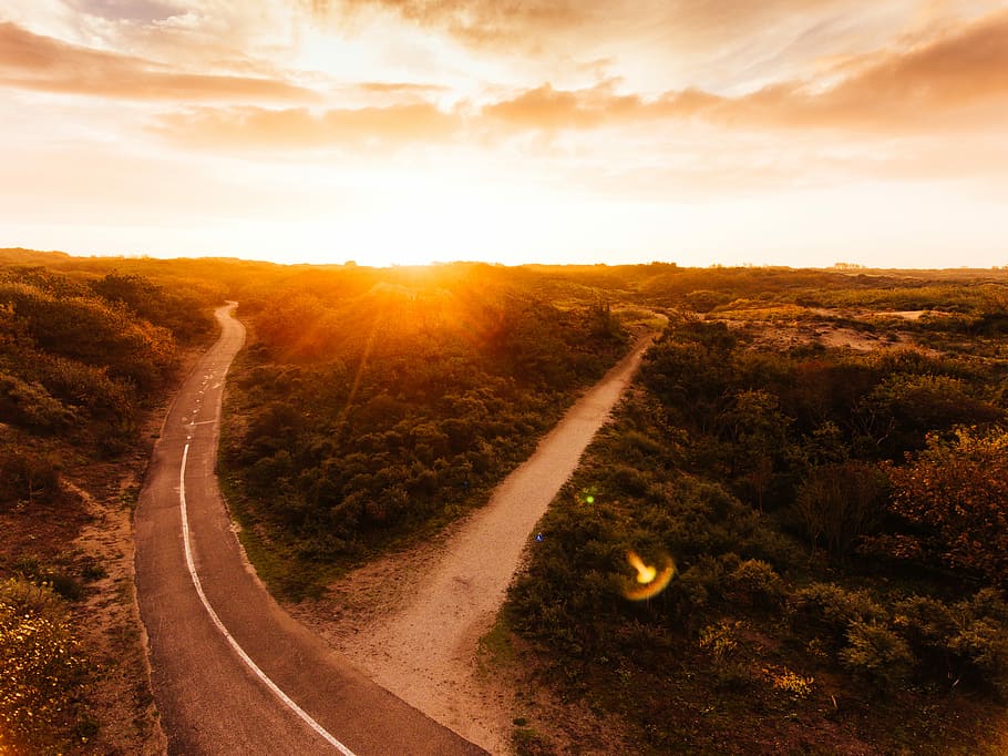 Dunes, aerial photography of two asphalt and dirt road near trees HD wallpaper