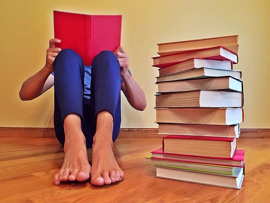 person reading book on floor beside pile of books, learning HD wallpaper