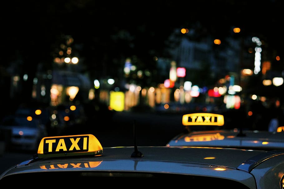 shallow focus photography of Taxi signage, lighted Taxi car LED