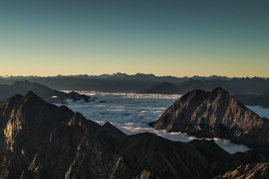 mountains surrounded with clouds in horizon, mountain range with clouds landscape photography HD wallpaper