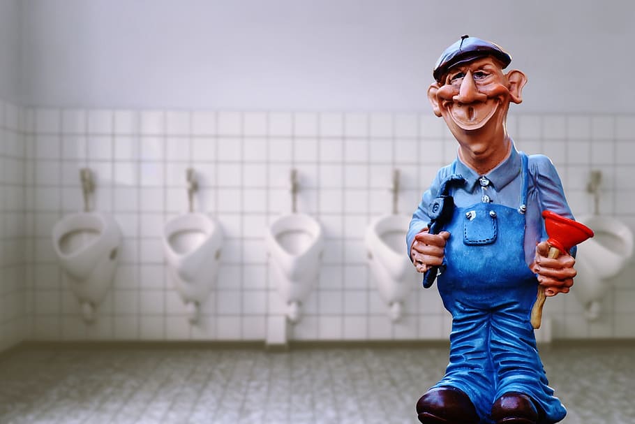 man in blue jumper standing near inside rest room, plumber, pömpel