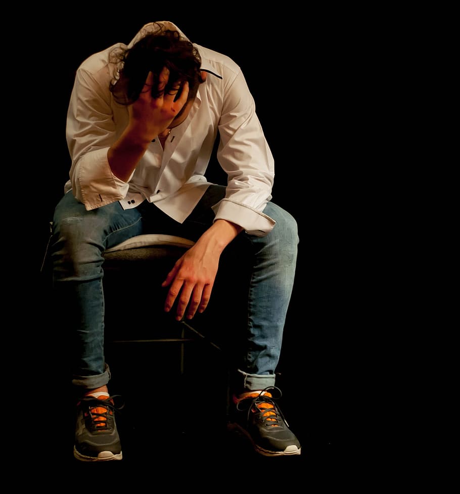 man wearing white dress shirt and blue denim jeans while sitting HD wallpaper